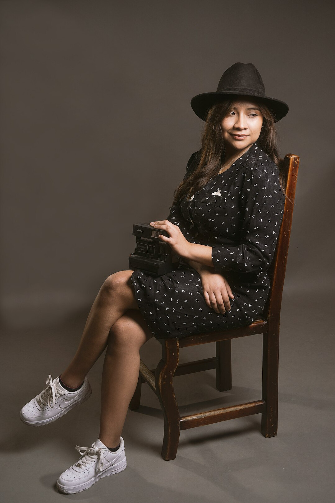 Studio portrait of a young Latina woman photographer smiling