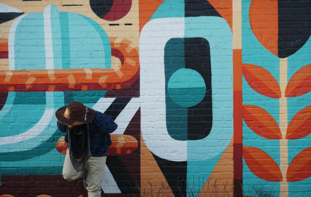 Large colorful street art mural on a city wall