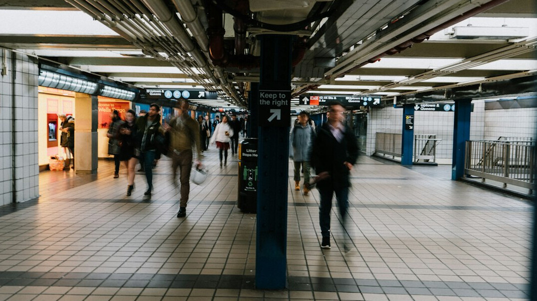 Commuters walking through an underground metro station